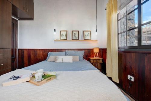 a bedroom with a bed with a pair of glasses on it at Finca Viña Maria in Los Realejos