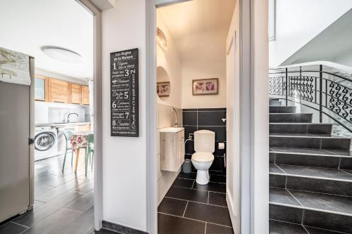 a bathroom with a toilet and a staircase at Villa L'Oranaise in Cluses