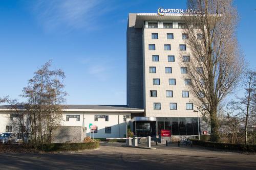 a building with a sign on the side of it at Bastion Hotel Dordrecht Papendrecht in Dordrecht