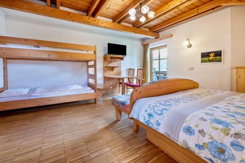 a bedroom with two bunk beds and a desk at Lindenhof Apt 3 in Vandoies