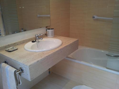a bathroom with a sink and a bath tub at Casa La Marina in Llanes