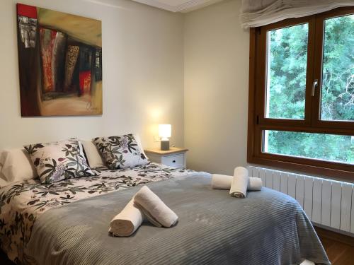 a bedroom with a bed with towels on it at Casa La Marina in Llanes