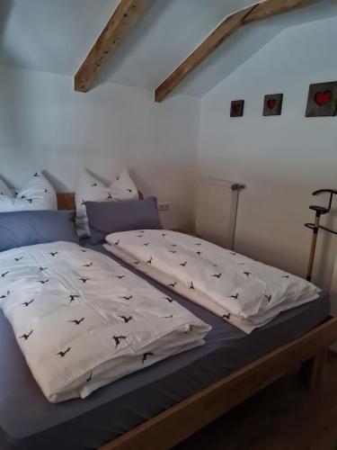 a bedroom with a bed with birds on it at Ferienwohnung Wetterstein in Mittenwald
