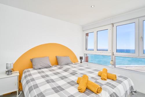 a bedroom with a bed with two stuffed animals on it at Atico Carabela By Ist in Torrox