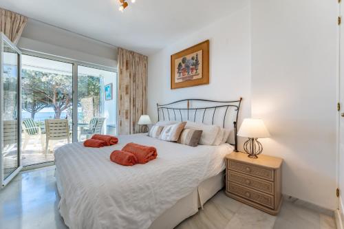 a bedroom with a large bed and a balcony at Mi capricho Beachfront Apt in Mijas