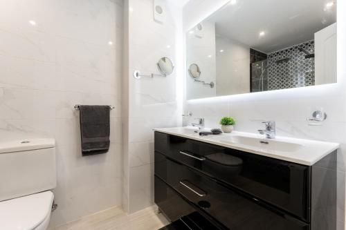 a bathroom with a sink and a toilet at Mi capricho Beachfront Apt in Mijas