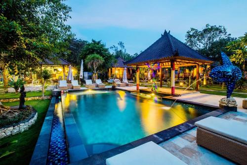 a swimming pool in front of a house with a gazebo at Sunset Garden Nusa Lembongan in Nusa Lembongan