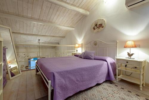 a bedroom with a purple bed and a ceiling at Alghero Old Town Gem - Sardinia in Alghero