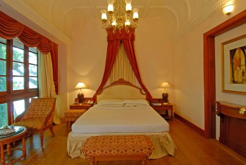 a bedroom with a bed with a canopy at KTDC Bolgatty Palace & Island Resort in Cochin