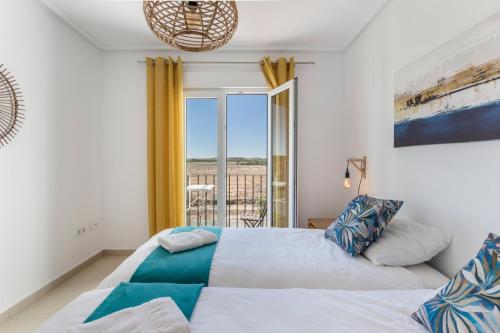 a bedroom with a bed with a view of the ocean at Casadeluxe Riquelme in Sucina