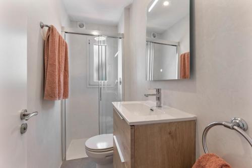 a bathroom with a sink and a toilet and a shower at La Gardenia 41 in Es Castell