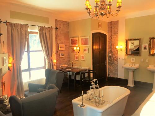 a living room with a bath tub and a table at Zabola Estate - Transylvania in Zăbala