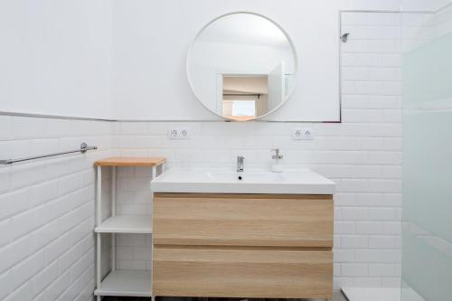 a bathroom with a sink and a mirror at Ático deluxe Corralejo centro in Corralejo