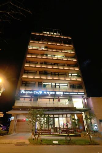 a tall building with a sign on it at night at ISPAVITA B&B Resort in Jiaoxi
