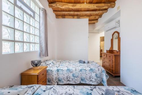 a bedroom with a bed and a large window at Casa Rústica in Vélez de Benaudalla