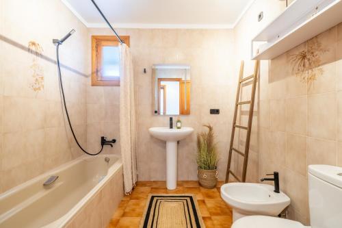 a bathroom with a sink and a toilet and a bath tub at Voramar Alcudia in Alcudia