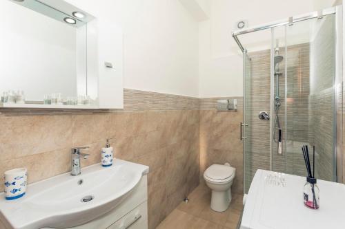 a bathroom with a sink and a toilet and a shower at Da Pina E Lu in Giardini Naxos