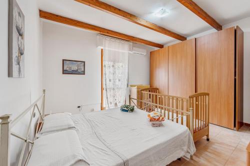 a bedroom with a bed and a crib at Casa rustica in Gonnesa