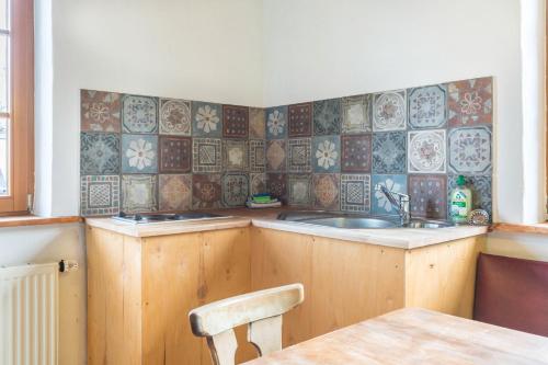 a kitchen with a sink and a chair in it at Ferienwohnung Tipihof in Sauldorf