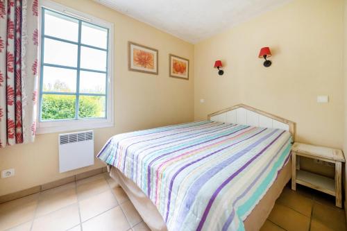 a bedroom with a bed and a window at Côte Basque in Urrugne