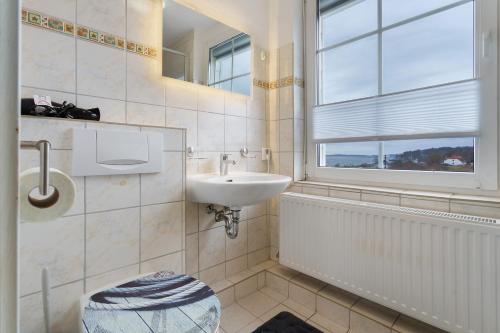 a bathroom with a sink and a window at Ferienwohnung oberhalb vom Hafen 2 in Sassnitz