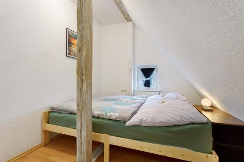 a bedroom with a bed with a wooden frame at Ferienwohnung oberhalb vom Hafen 2 in Sassnitz