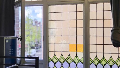 a view of a window with stained glass at Hostel Cosmos Amsterdam in Amsterdam