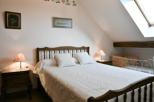 a bedroom with a bed with two lamps on tables at Gîte Yveco in Châteauneuf
