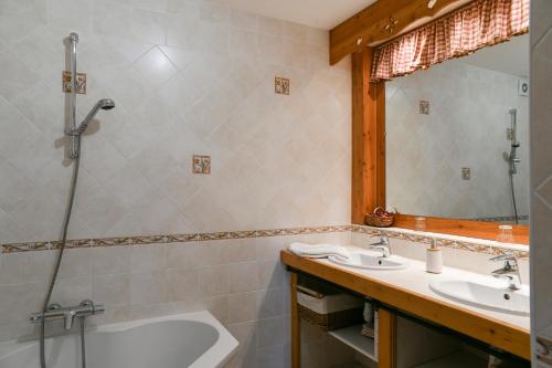 a bathroom with two sinks and a shower at Gîte Yveco in Châteauneuf