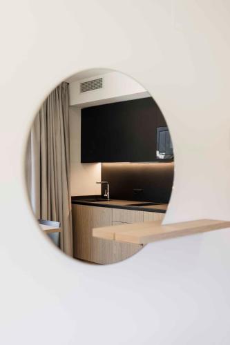 a view of a hotel room with a mirror at Trianglhof surrounded by vineyards in Bolzano