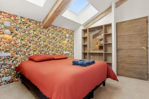 a bedroom with a large orange bed in a room at La Master Grange De Queyran in La Palud-sur-Verdon