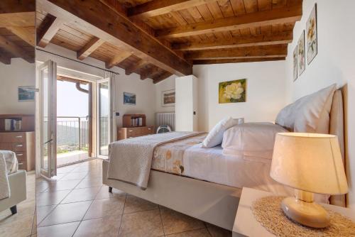 a bedroom with a bed and a table with a lamp at Splendido loft panoramico in Veleso