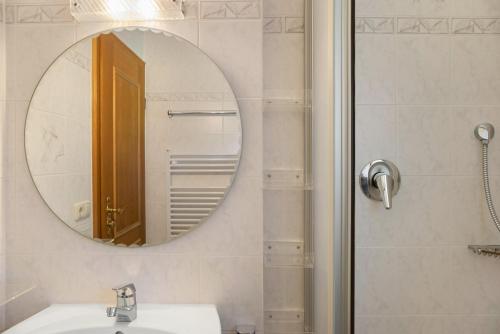 a bathroom with a mirror and a sink at Ammerheimat in Oberammergau