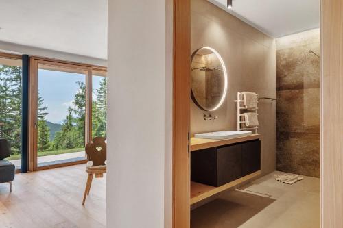 a bathroom with a sink and a mirror at Chalet Magdalena und Lodges in Avelengo
