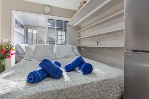 a bedroom with a bed with blue towels on it at Sea and Sunset Love in San Marcos