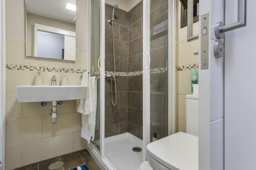 a bathroom with a shower and a sink and a toilet at Sea and Sunset Love in San Marcos