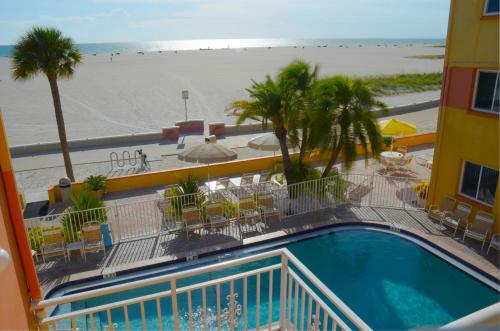 a view of a pool and the beach from a hotel at Page Terrace Beachfront Hotel in St Pete Beach
