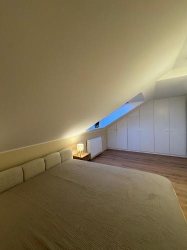 a large bedroom with a bed and a blue window at Apartment Oben in der Heide in Faßberg