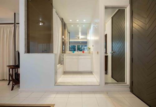 a bathroom with a door open to a bathroom with a sink at Seafront villa with jacuzzi in Maspalomas