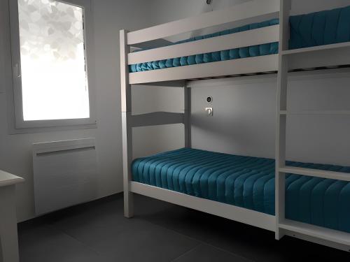 a room with bunk beds with a window at La Maison Du Marché - Balcon in La Tranche-sur-Mer