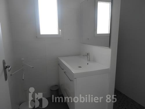 a white bathroom with a sink and a mirror at La Maison Du Marché - Balcon in La Tranche-sur-Mer