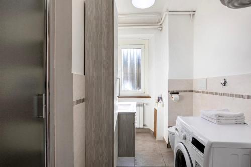 a bathroom with a washing machine and a sink at Casa Tua - Arvier in Arvier