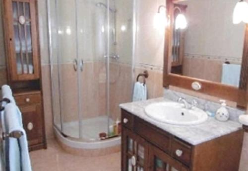 a bathroom with a shower and a sink and a mirror at Townhouse with Sea View in Nerja