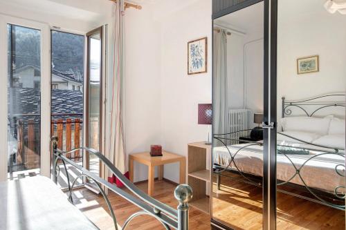 a bedroom with a bed and a balcony at Casa Tua - Arvier in Arvier