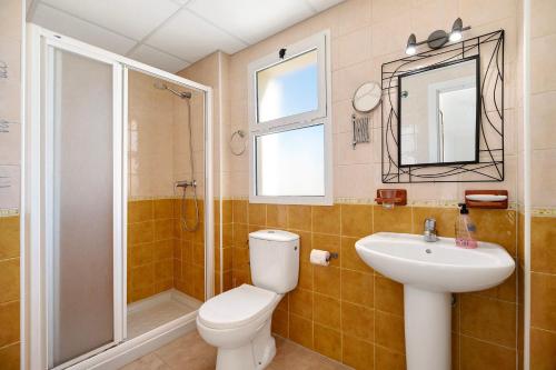 a bathroom with a toilet and a sink and a shower at Apartamento Merce in Rota