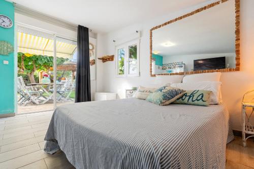 a bedroom with a bed and a large window at Beach house in Torredembarra
