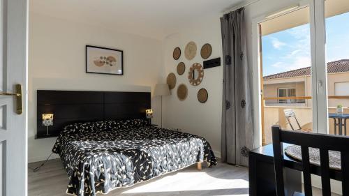 a bedroom with a black and white bed and a window at Virginia N 203 ST2 in Grasse