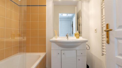 a bathroom with a sink and a bath tub at Virginia N 203 ST2 in Grasse