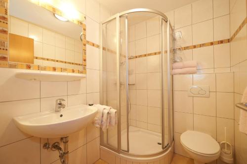 a bathroom with a shower and a sink and a toilet at Haus Weitgasser in Flachau