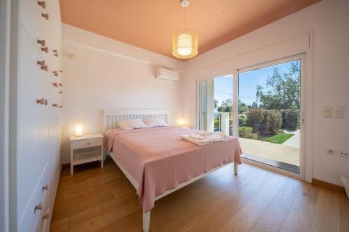 a bedroom with a bed and a large window at Blue Pine Villa in Marathon